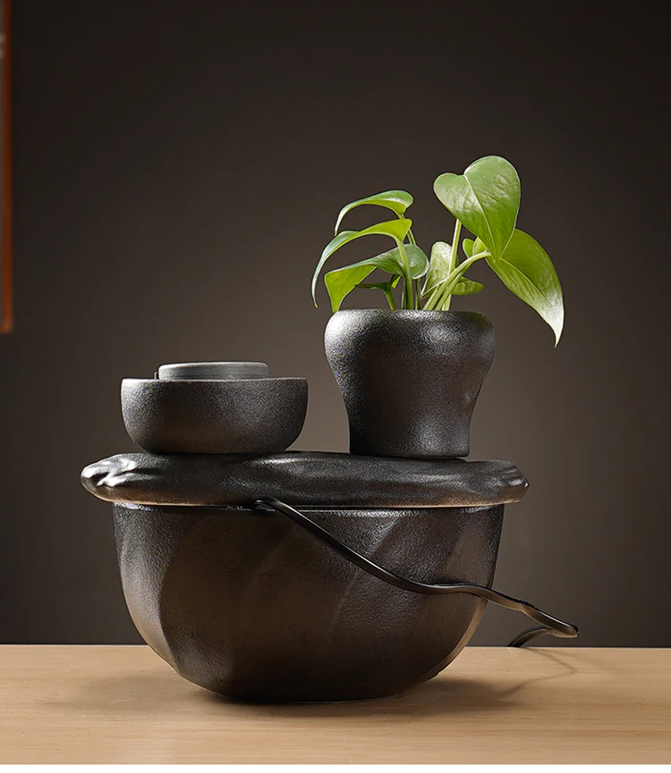 Rear view of the ceramic fountain showing the integrated plant holder, basin and power cable
