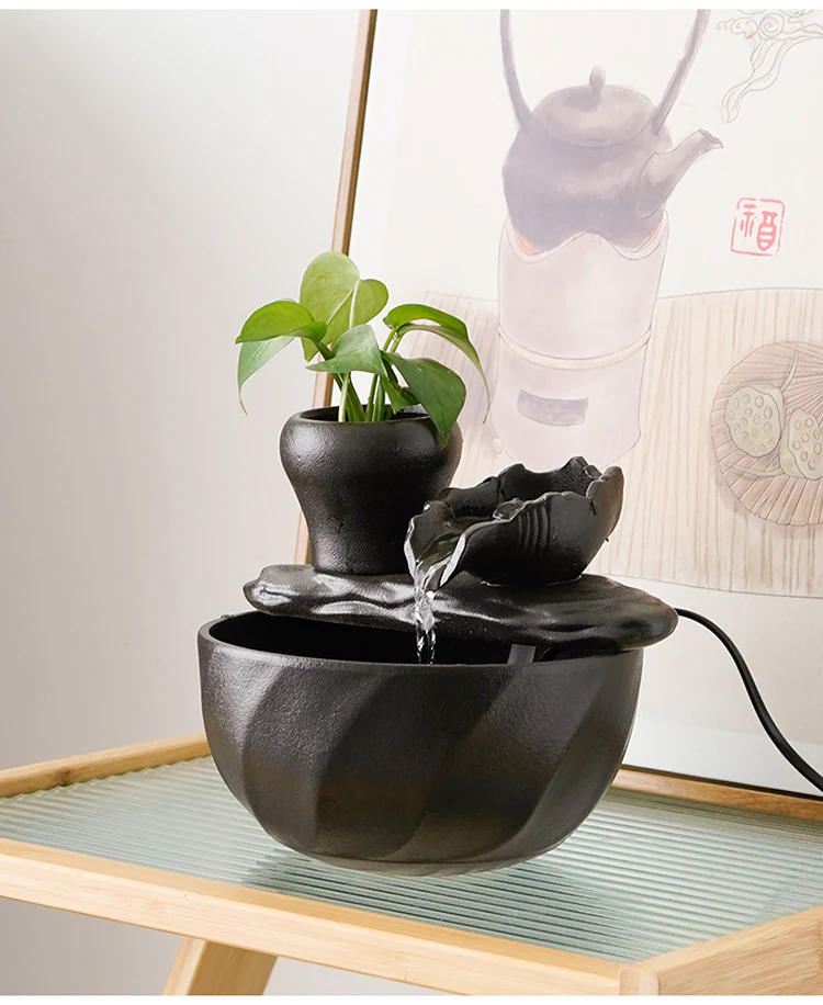 Ceramic fountain displayed on a pale green tea table in a home interior